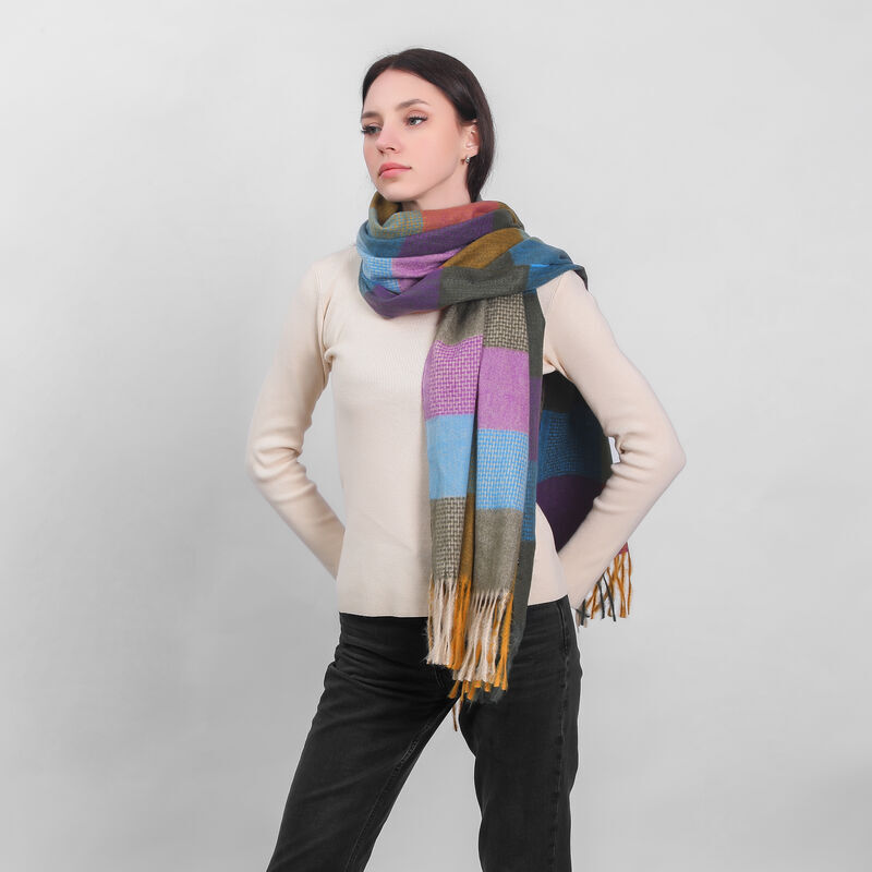 Woman wearing a colorful checkered scarf and beige sweater with hands on hips