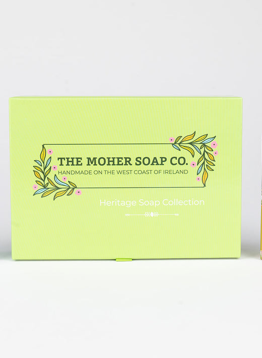 Five colorful handmade soap bars and a green Heritage Soap Collection box