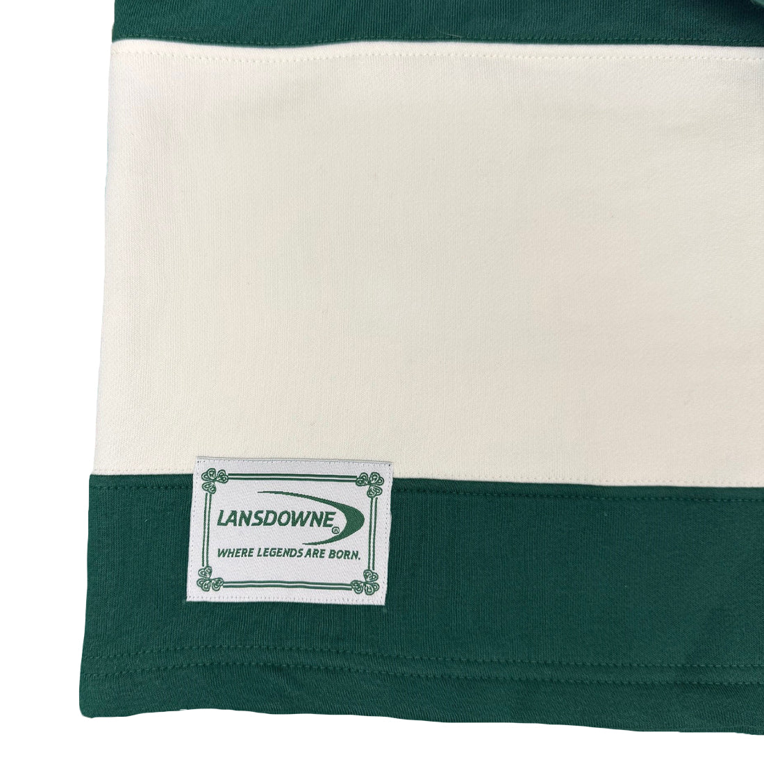 Close up of the striped rugby shirt hem featuring a Lansdowne patch.