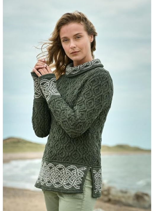 Woman wearing green patterned sweater standing near a beach on a cloudy day