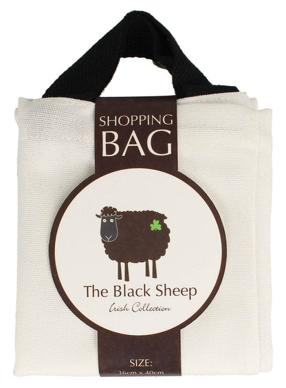 White canvas tote bag with black handles and a circular label featuring a cartoon black sheep