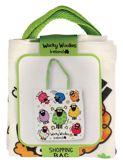Small white Wacky Woolies Ireland shopping bag with a playful sheep print and lime green handles on display packaging