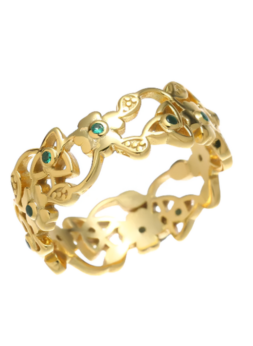 Gold ring with intricate floral and geometric cutout design and green stones