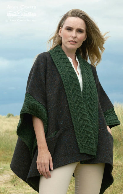 Model wearing Ladies Donegal Merino Wool and Tweed Army Green Cape with green braided cable trim outdoors