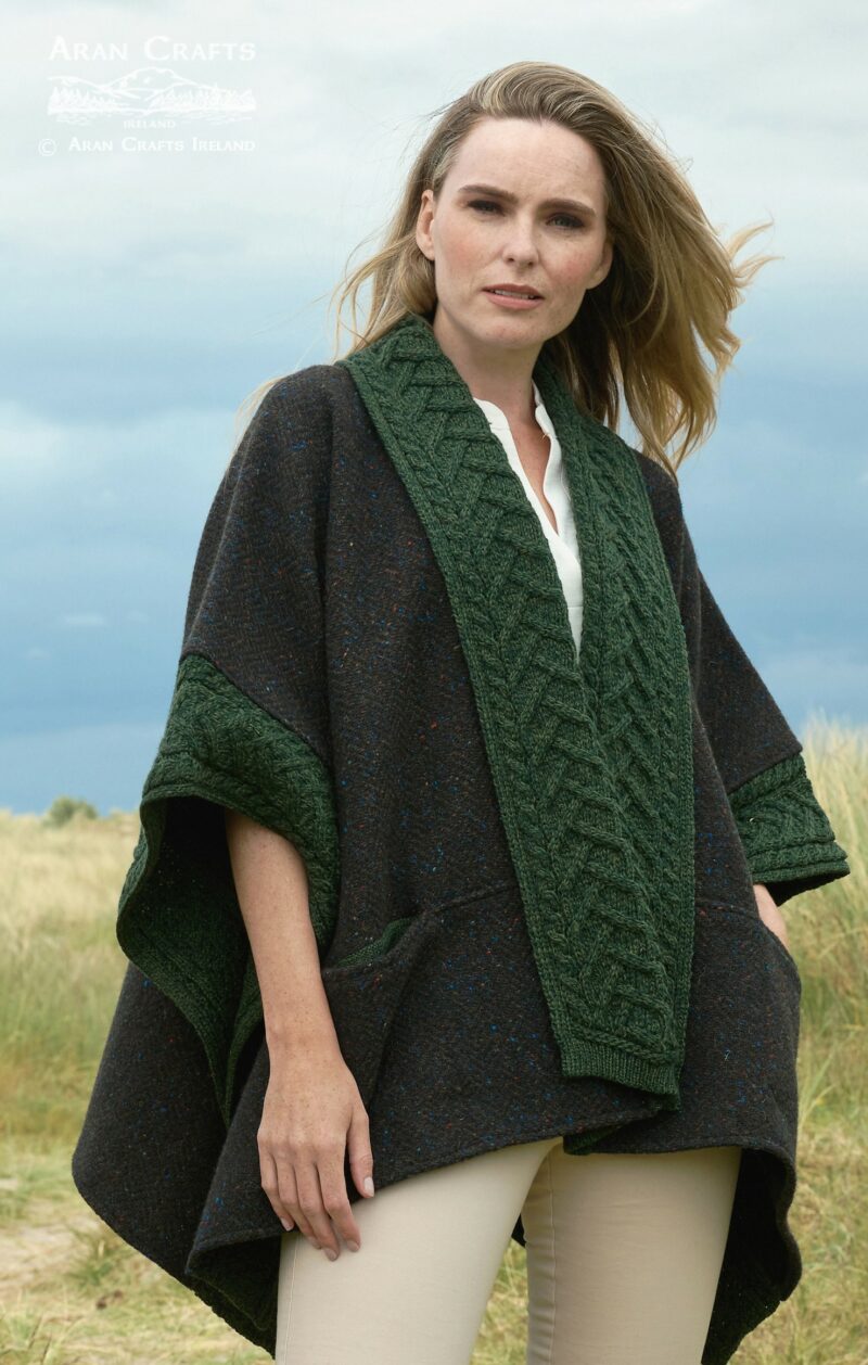 Model wearing Ladies Donegal Merino Wool and Tweed Army Green Cape with green braided cable trim outdoors