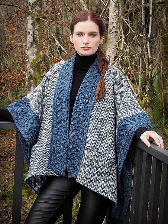 Woman with braided hair wearing a blue and gray knitted shawl outdoors