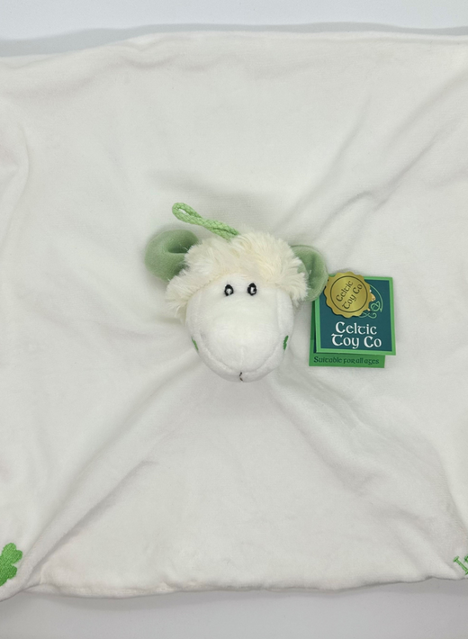 White plush baby blanket with green shamrock and sheep head in center