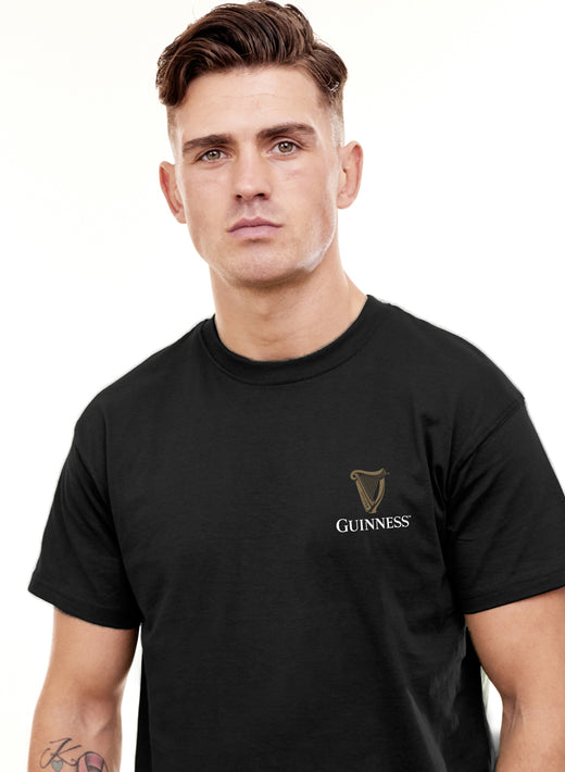 Young man with short hair wearing black Guinness t-shirt
