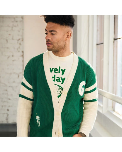 Male model wearing green and cream cardigan with white sleeves and large Guinness Ireland logo on the back