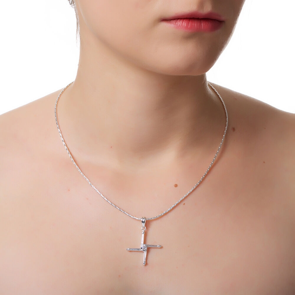 Close-up of neck wearing silver cross pendant necklace